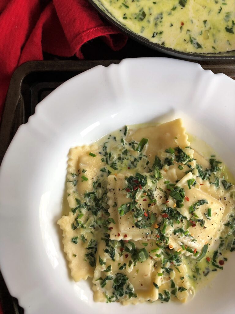 Ravioli in Creamy Garlic and Spinach White Sauce