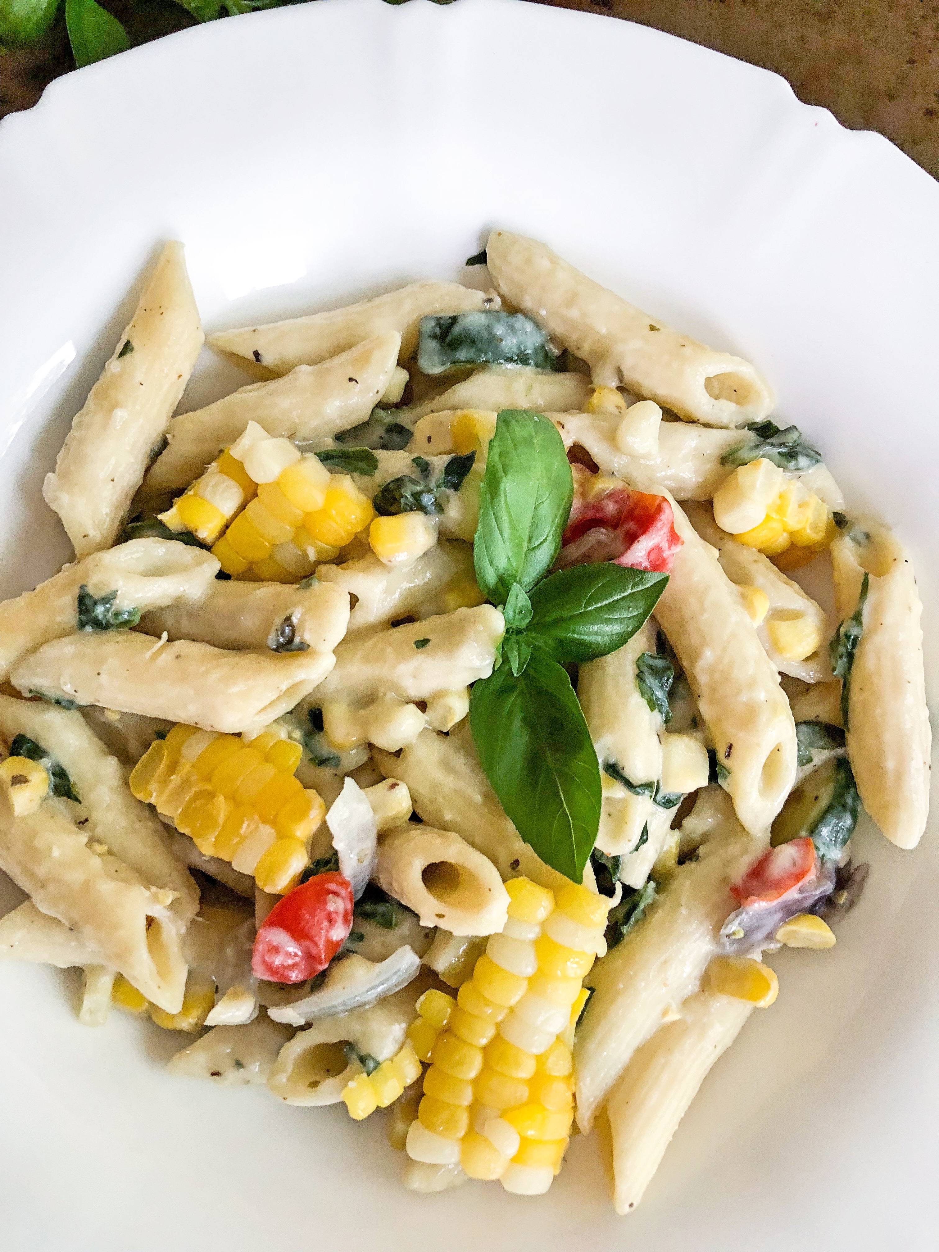 Corn, Zucchini and tomato summer pasta in lightened up and healthier alfredo sauce
