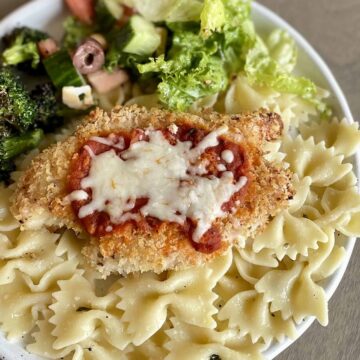 Baked-Chicken-Parmesan-_FI_plated-with-pasta-and-sides