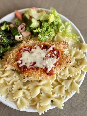 Baked-Chicken-Parmesan-_FI_plated-with-pasta-and-sides