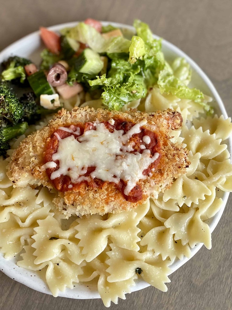 Baked-Chicken-Parmesan-_FI_plated-with-pasta-and-sides