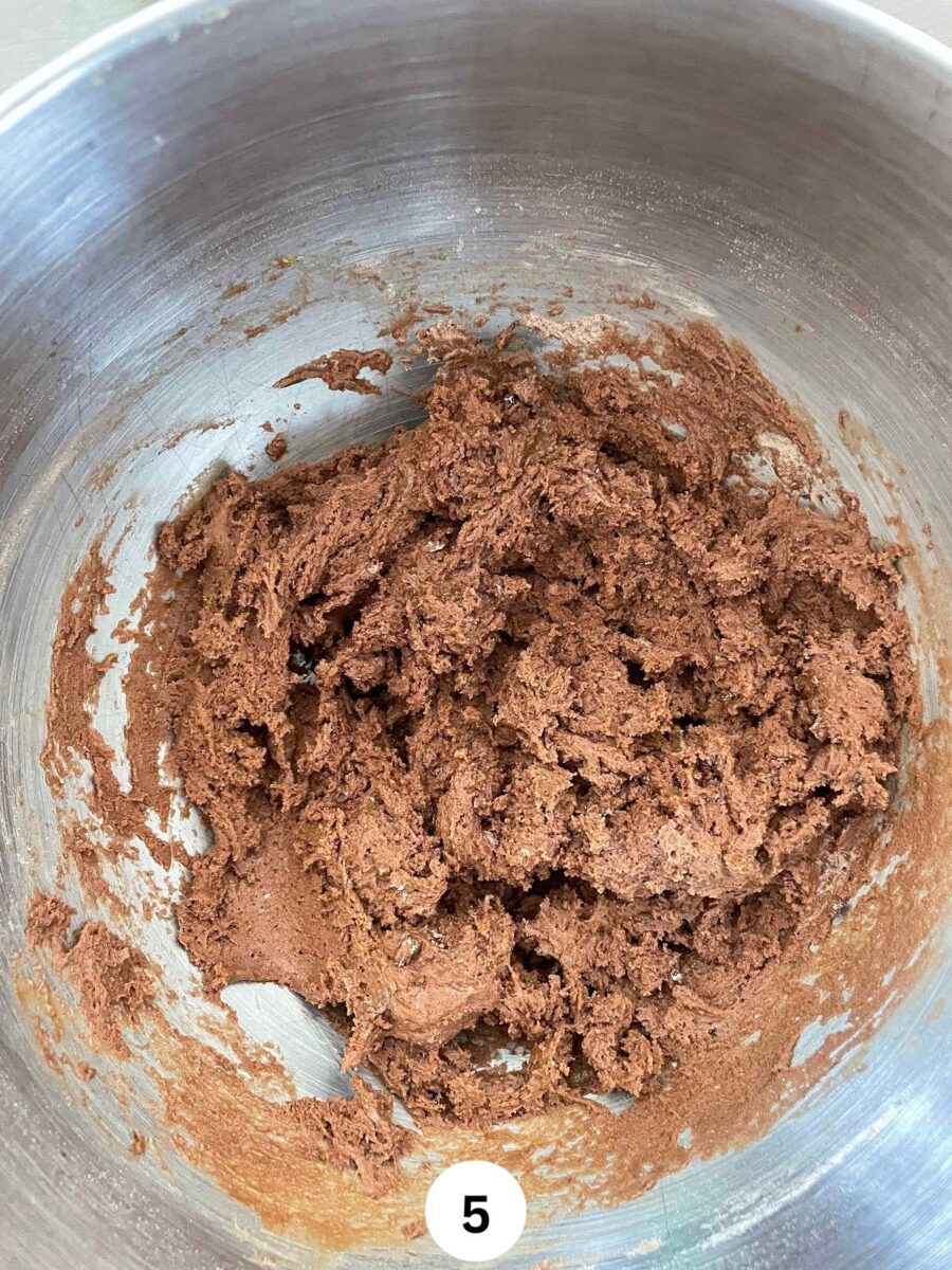 chocolate muffin batter in a stainless steel mixing bowl.