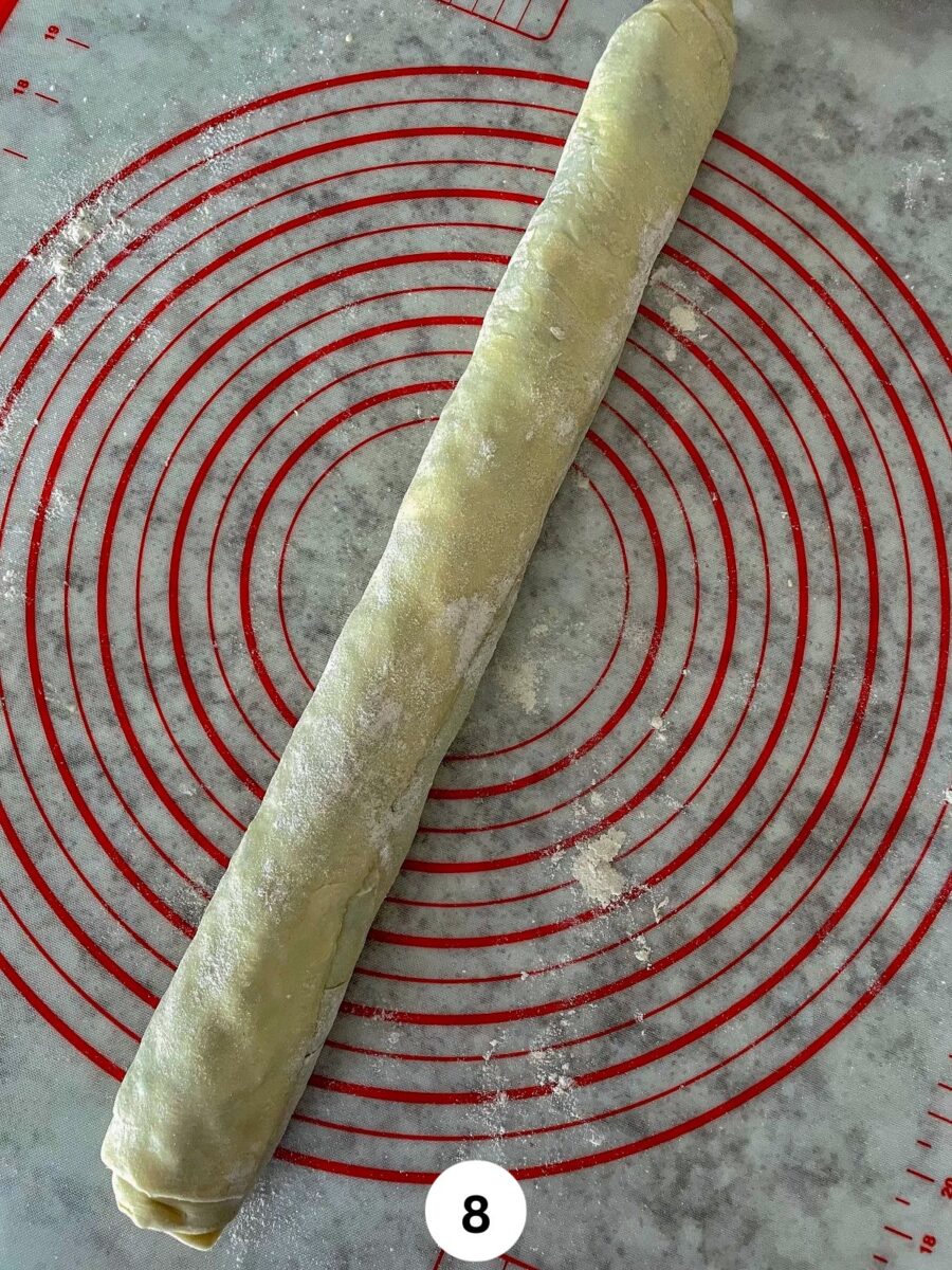 A log of samosa appetizer pinwheel on a silicon rolling mat.