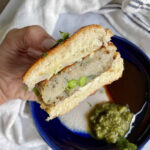 Sliced Aloo Tikki Slider in hand.
