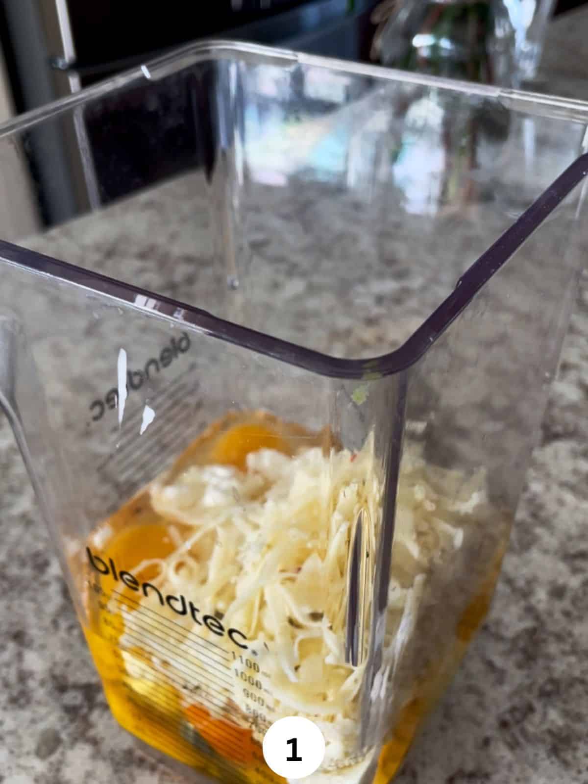Egg whites and yokes, cottage cheese, and shredded cheese in the jar of a blender.