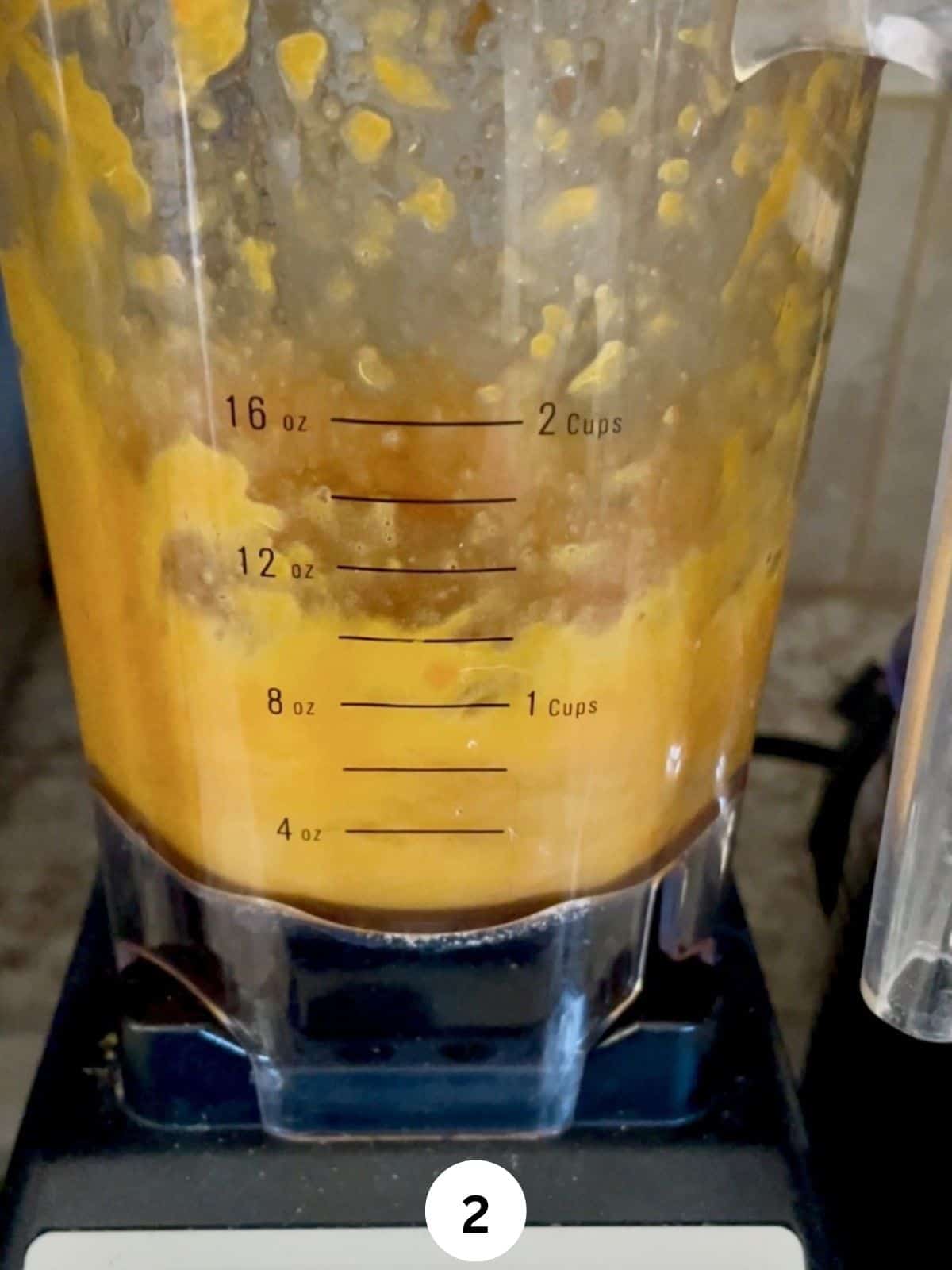 Blended oranges in a jar of a blender.