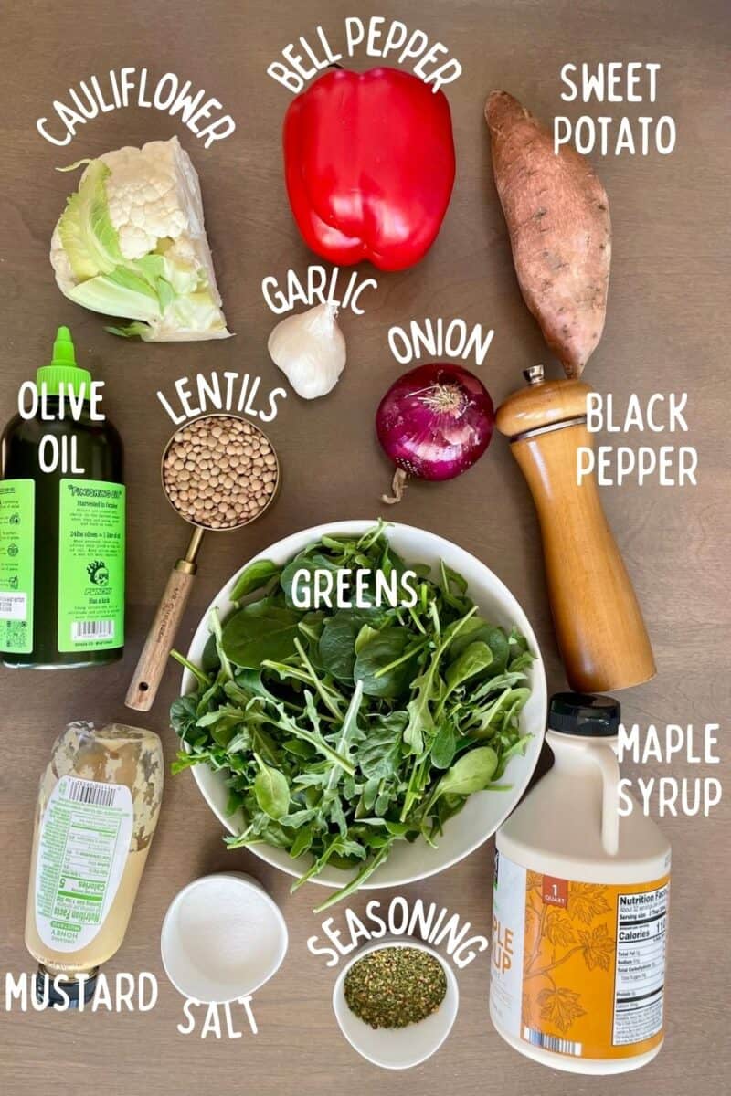 Ingredients for lentil and roasted vegetable salad including sweet potato, cauliflower, seasoning, oil, maple syrup, and garlic.