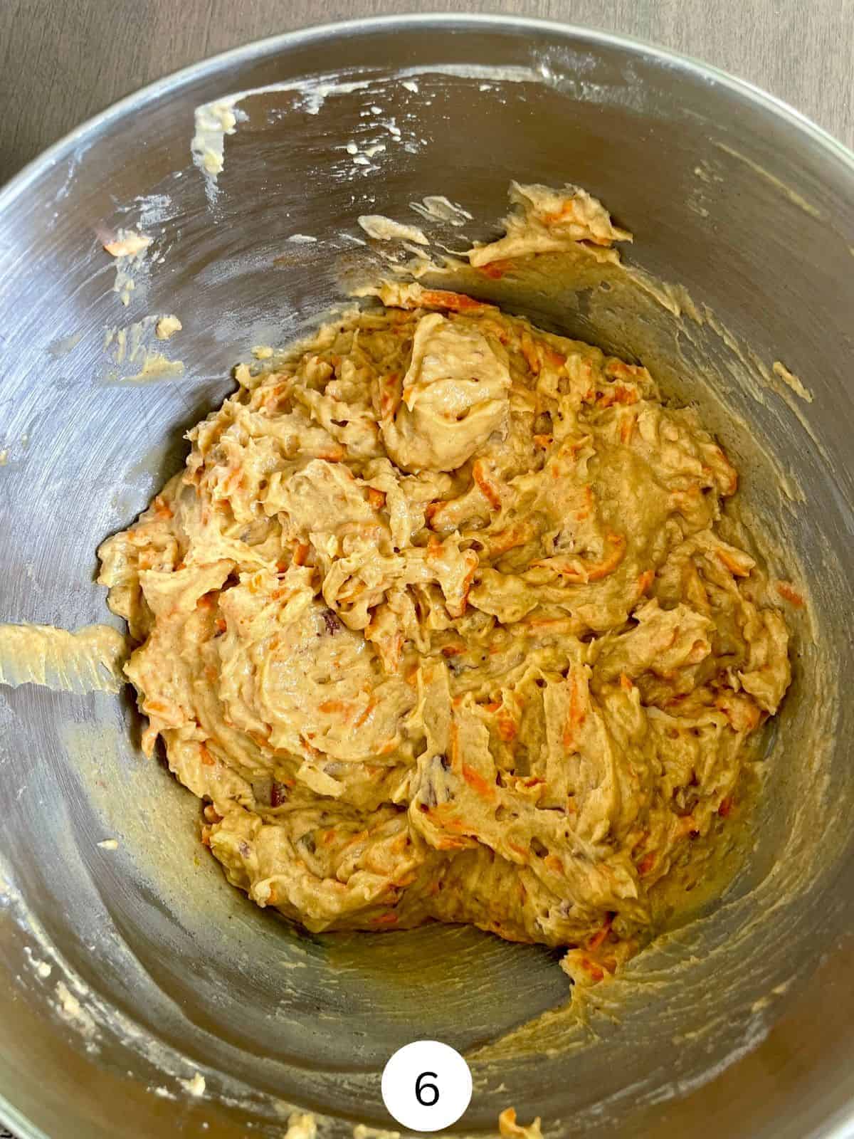 Carrot cake batter in a stainless steel mixing bowl.