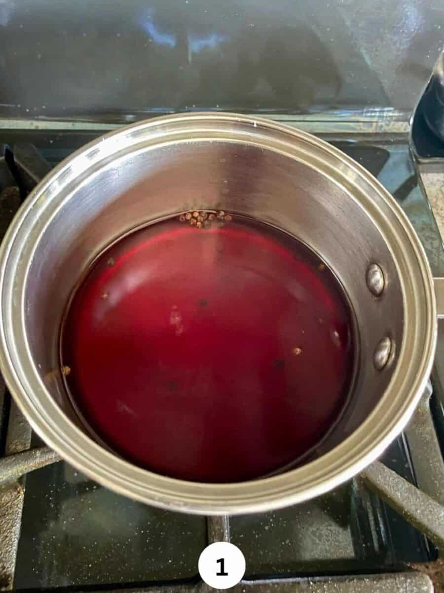 Pickling liquid in a stainless steel saucepan on a stove.