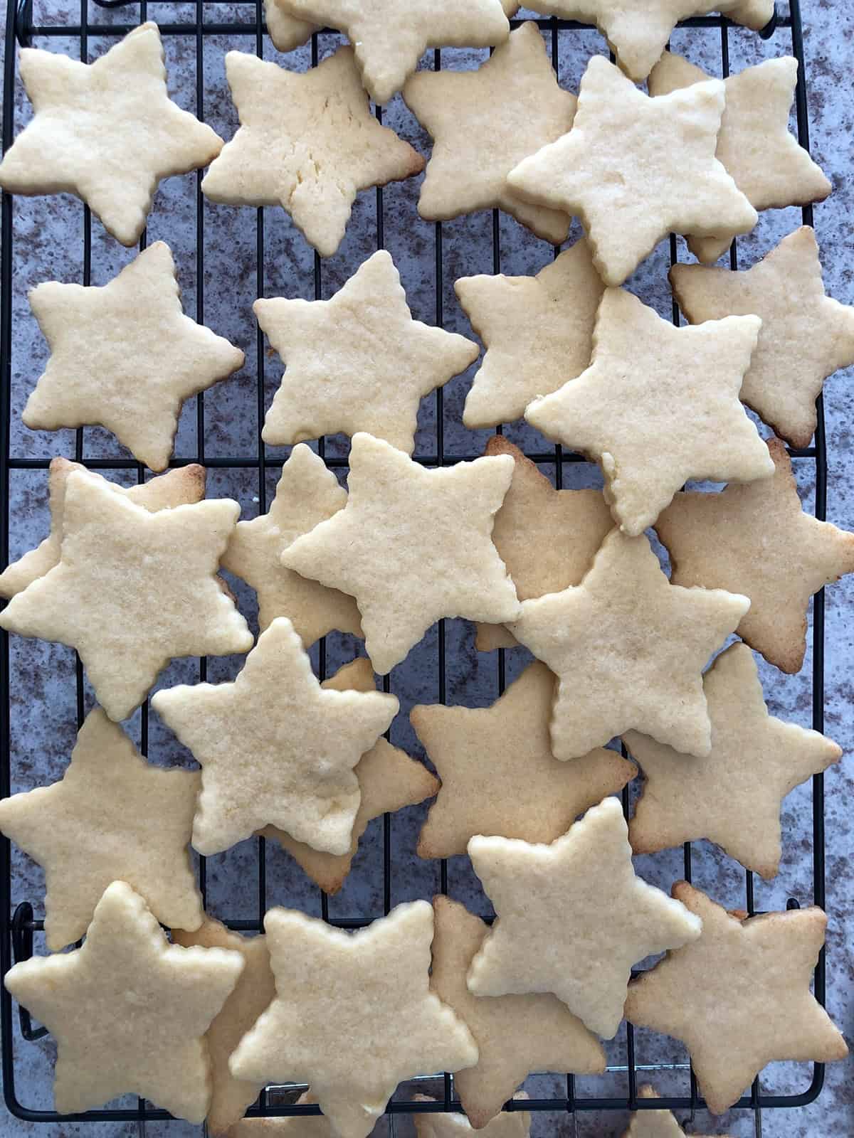 Star-shaped cut-out cookies on a cooling rack.