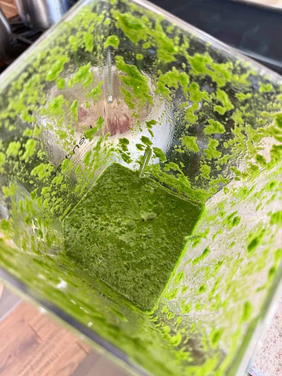 Pureed spinach in a blender jar.