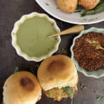 Mumbai vada pav served with green chutney and spicy powder, perfect for snacks or appetizers.