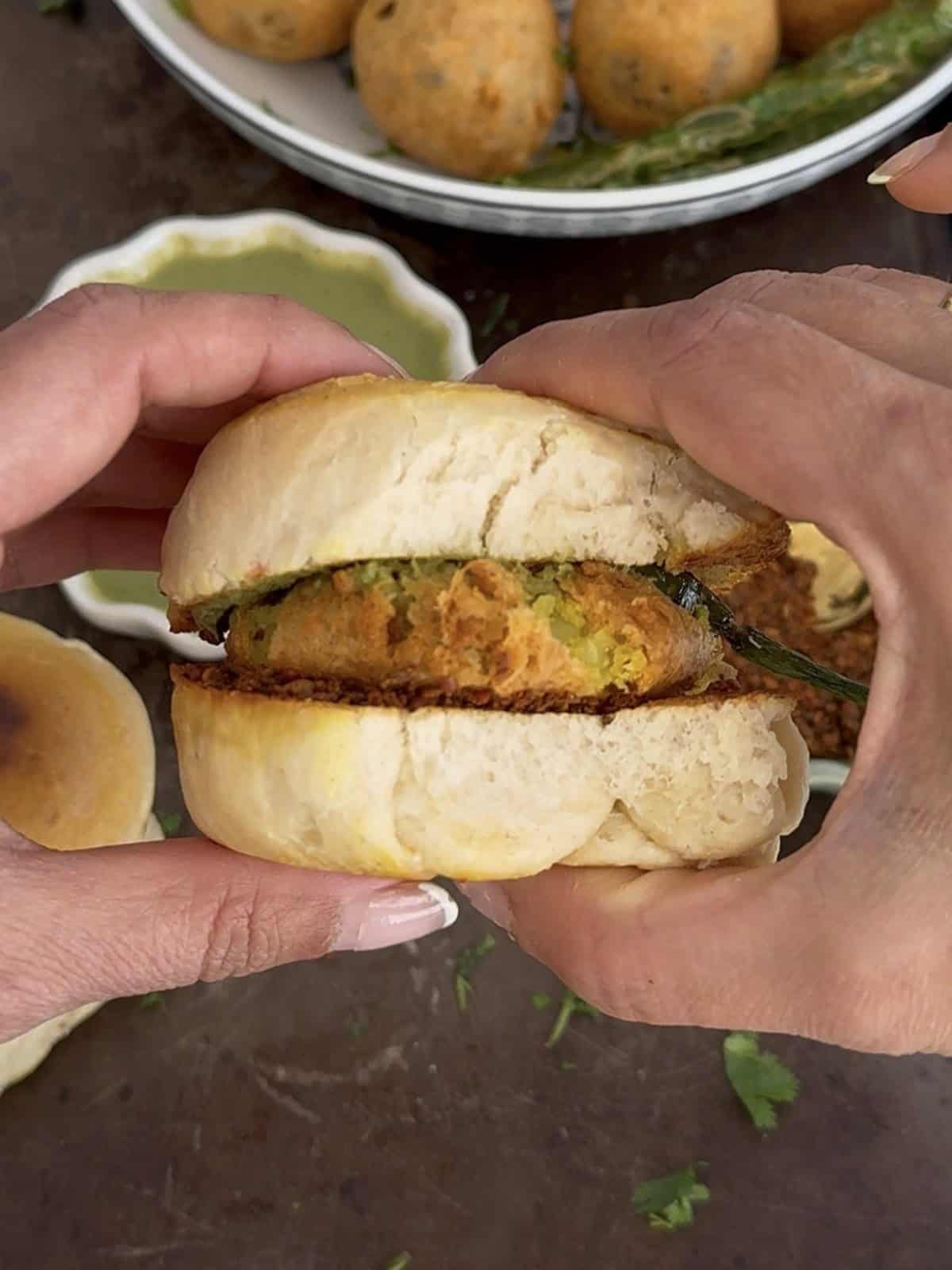 Freshly made Mumbai Vada Pav with crispy potato patty and soft bun, served with side dishes. Perfect for a healthy, delicious meal at The Kitchen Docs.