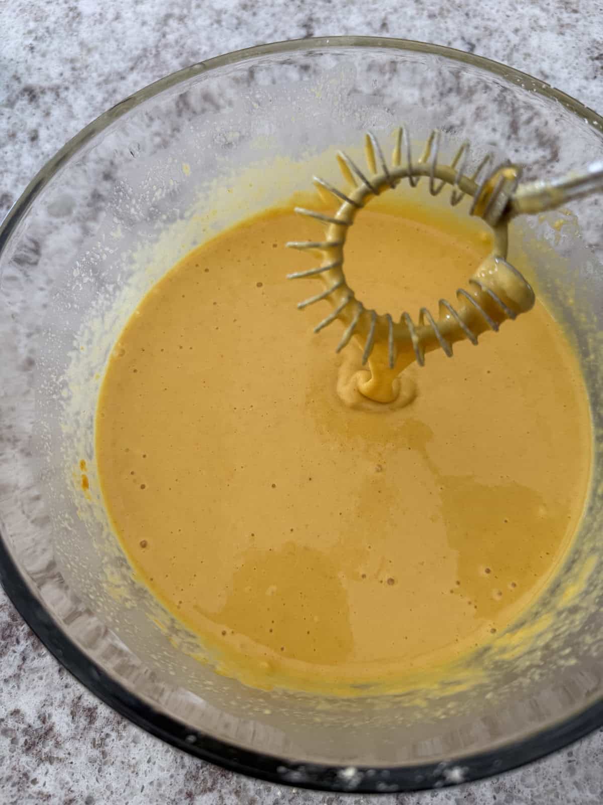 Chickpea flour batter in a glass bowl.
