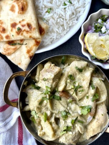 Afghani chicken without cashews with caramelized onions and blistered lemon and green chili slices. Served with naan, rice and lemon slices.