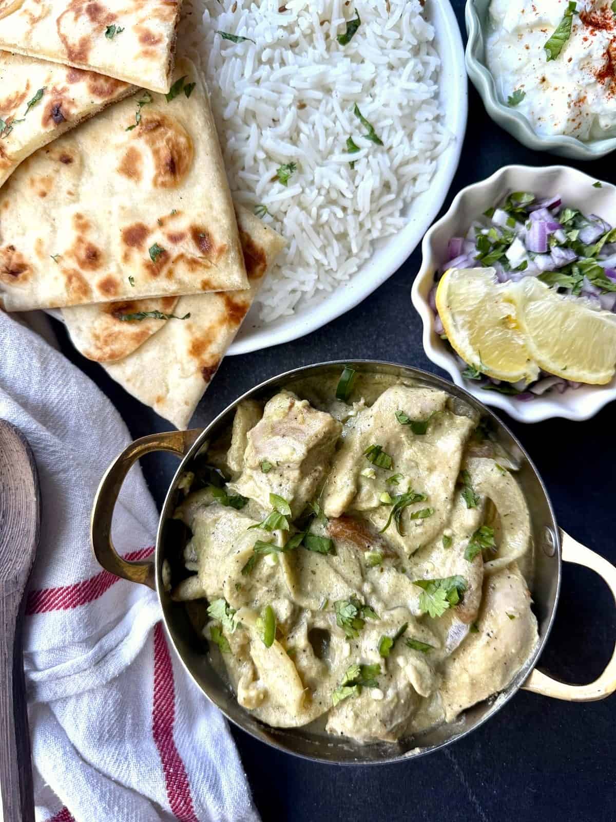 Afghani chicken without cashews, with caramelized onions and blistered lemon slices and green chilies.