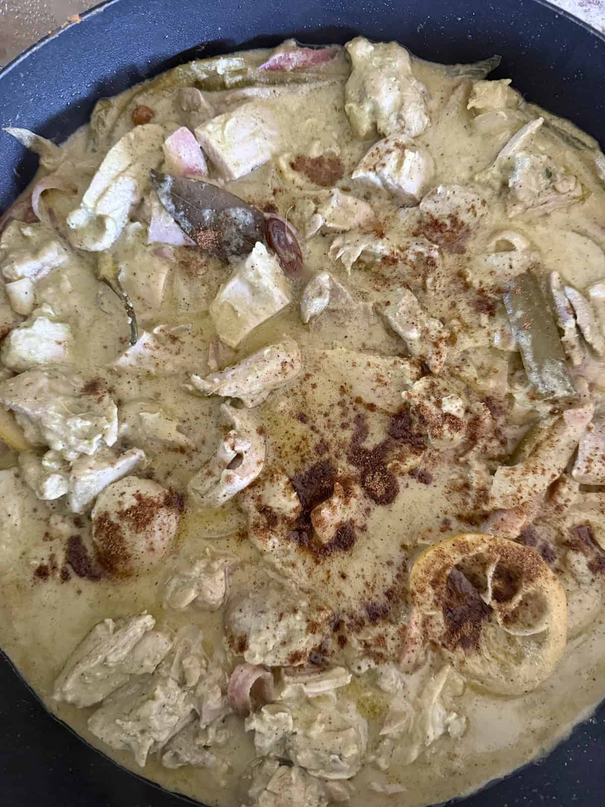 Afghani chicken without cashews, cooked in a skillet and finished with garam masala.