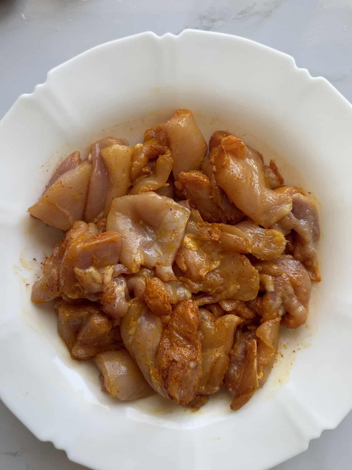 Marinated chicken in a plate.