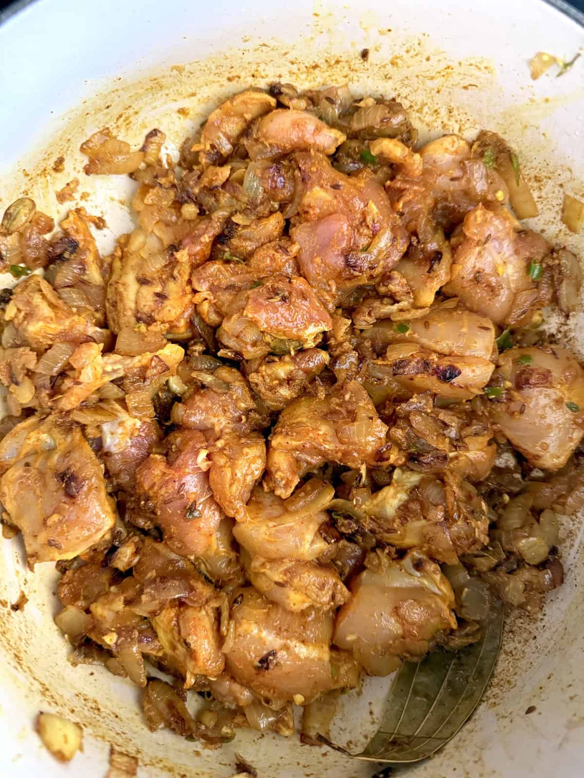 Easy weeknight punjabi chicken curry cooking in an enameled cast iron pot.