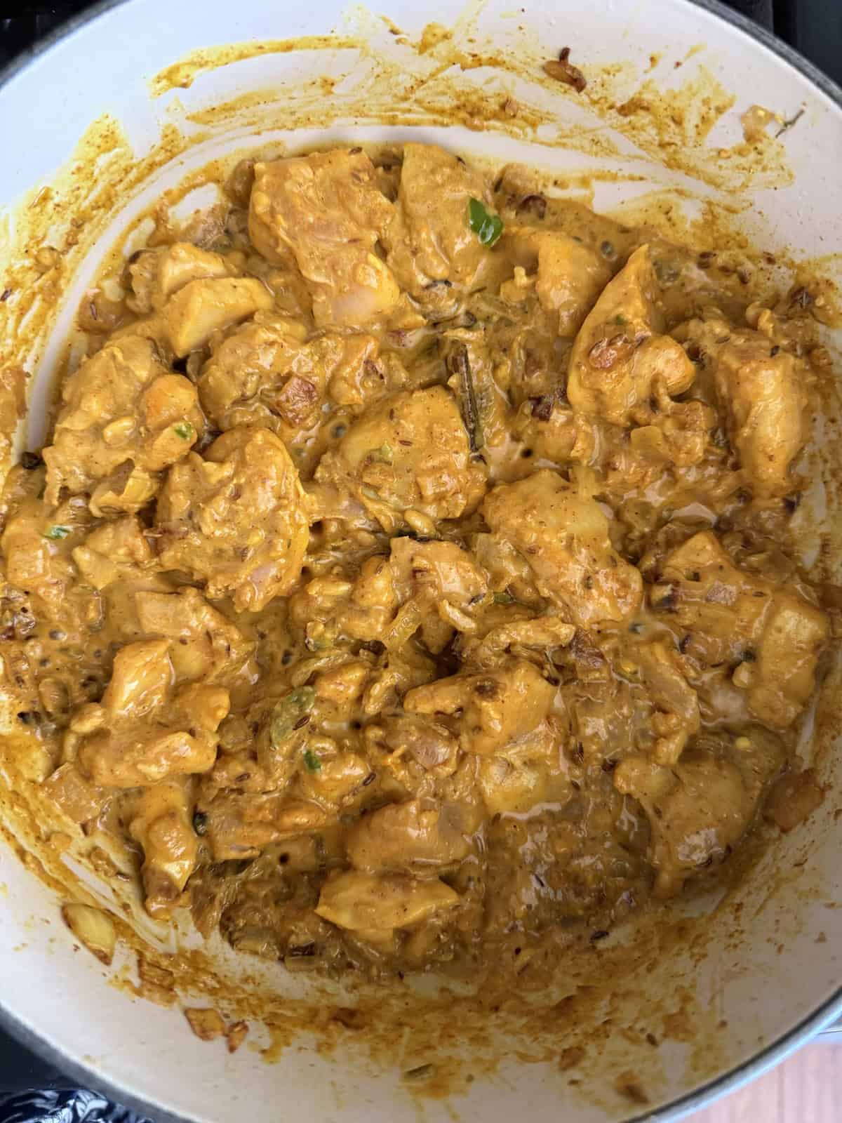 Easy weeknight punjabi chicken curry in an enameled cast iron pot.