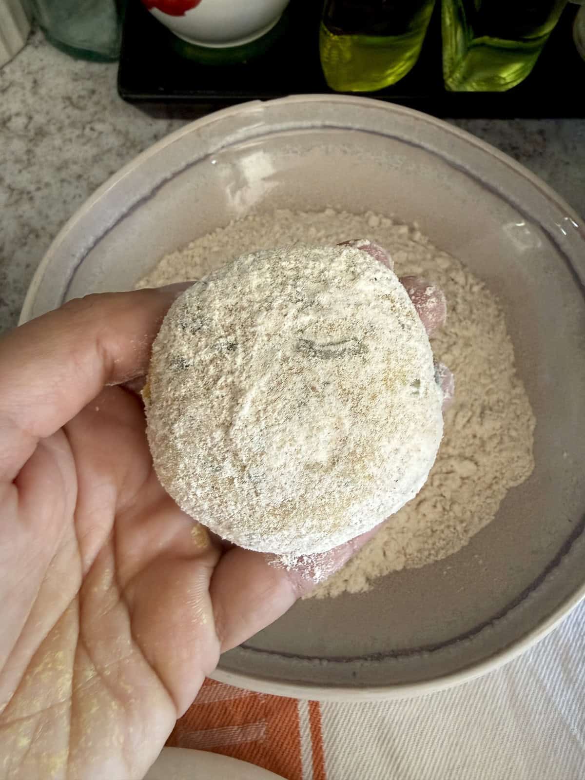 A dough ball dusted with flour before rolling.