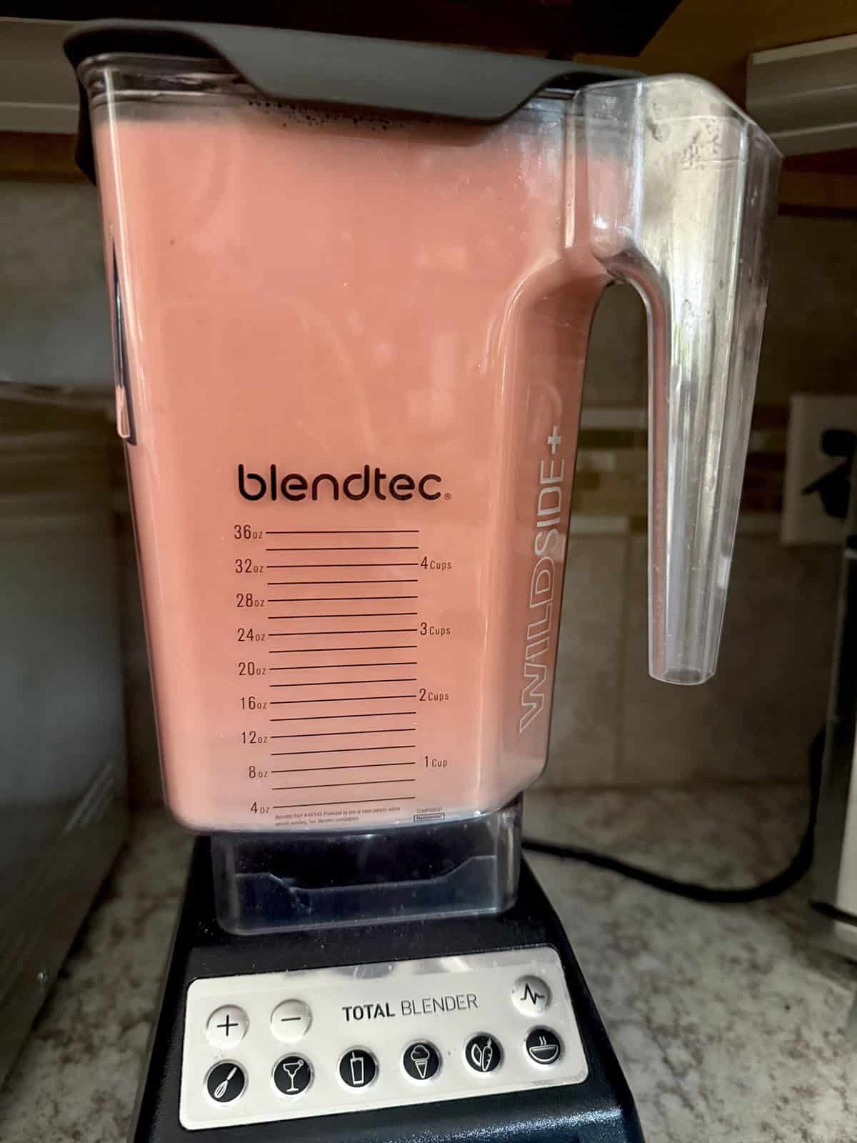 Blender jar with blended watermelon and mint juice.