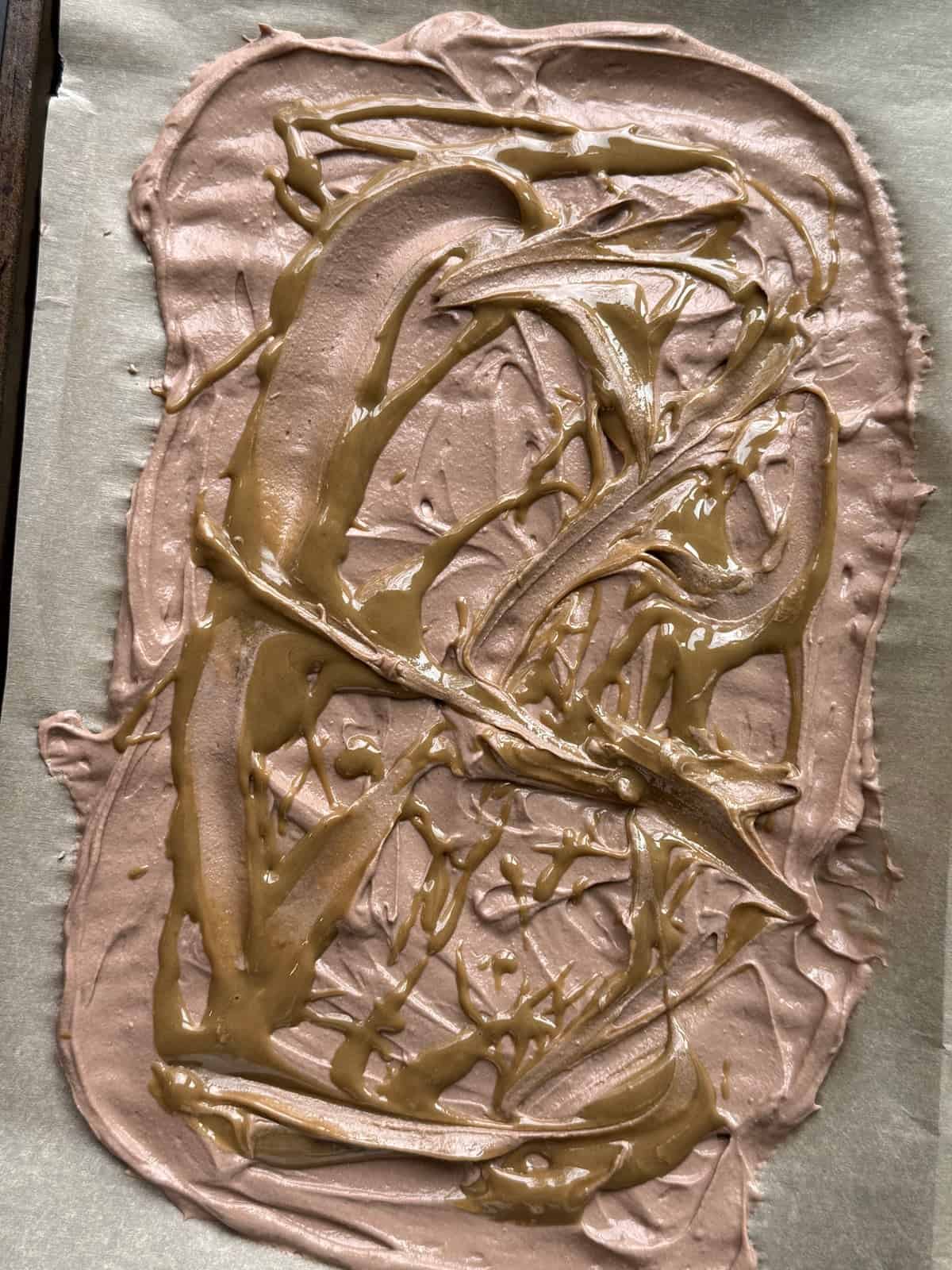 Swirling sunflower seed butter into chocolate yogurt bark base for a nut-free peanut butter cup flavor.