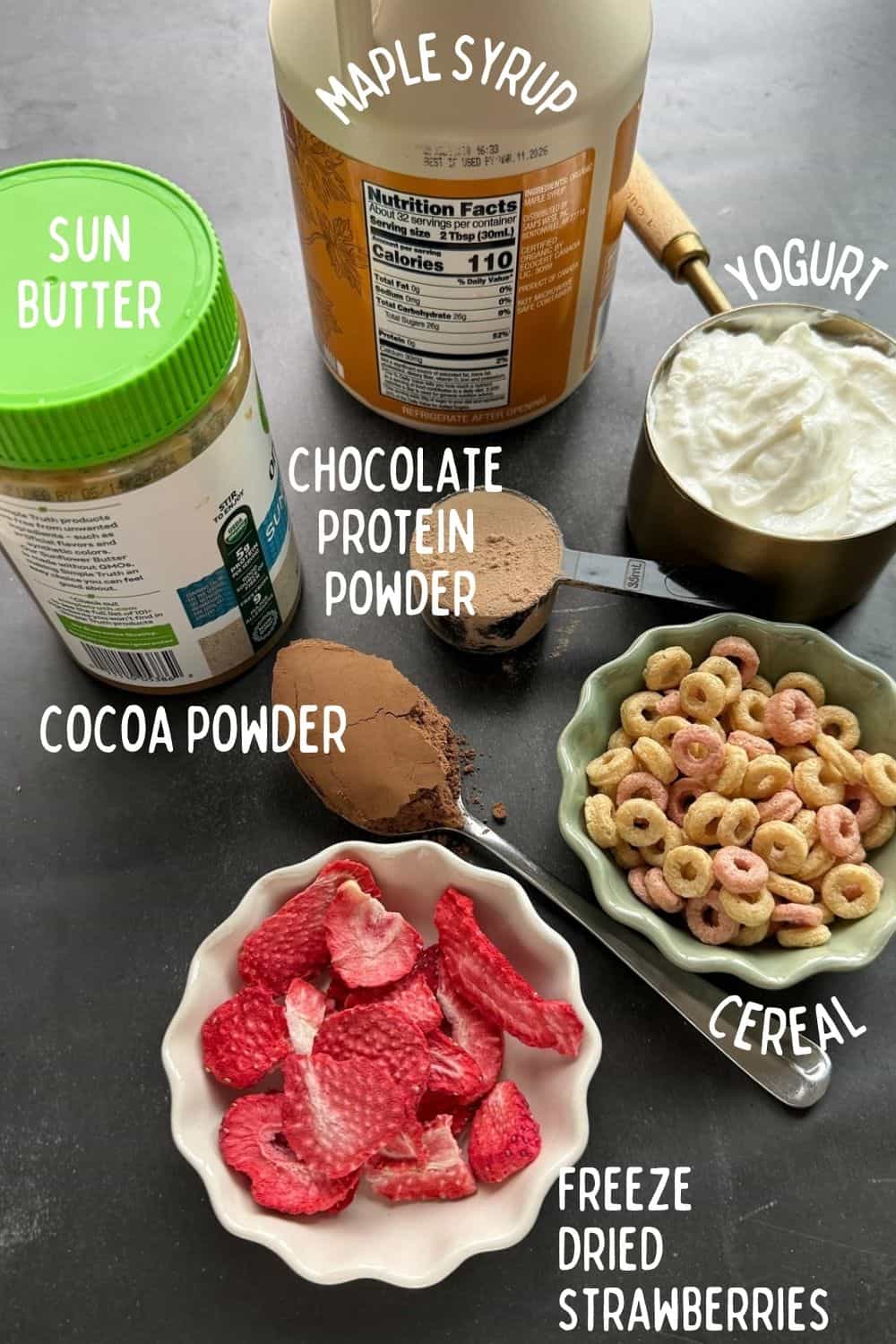 Ingredients for nut-free protein yogurt bark including Greek yogurt, chocolate protein powder, sunflower seed butter, dried strawberries and cereal