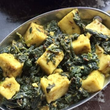 Delicious palak paneer curry served in a traditional Indian dish.