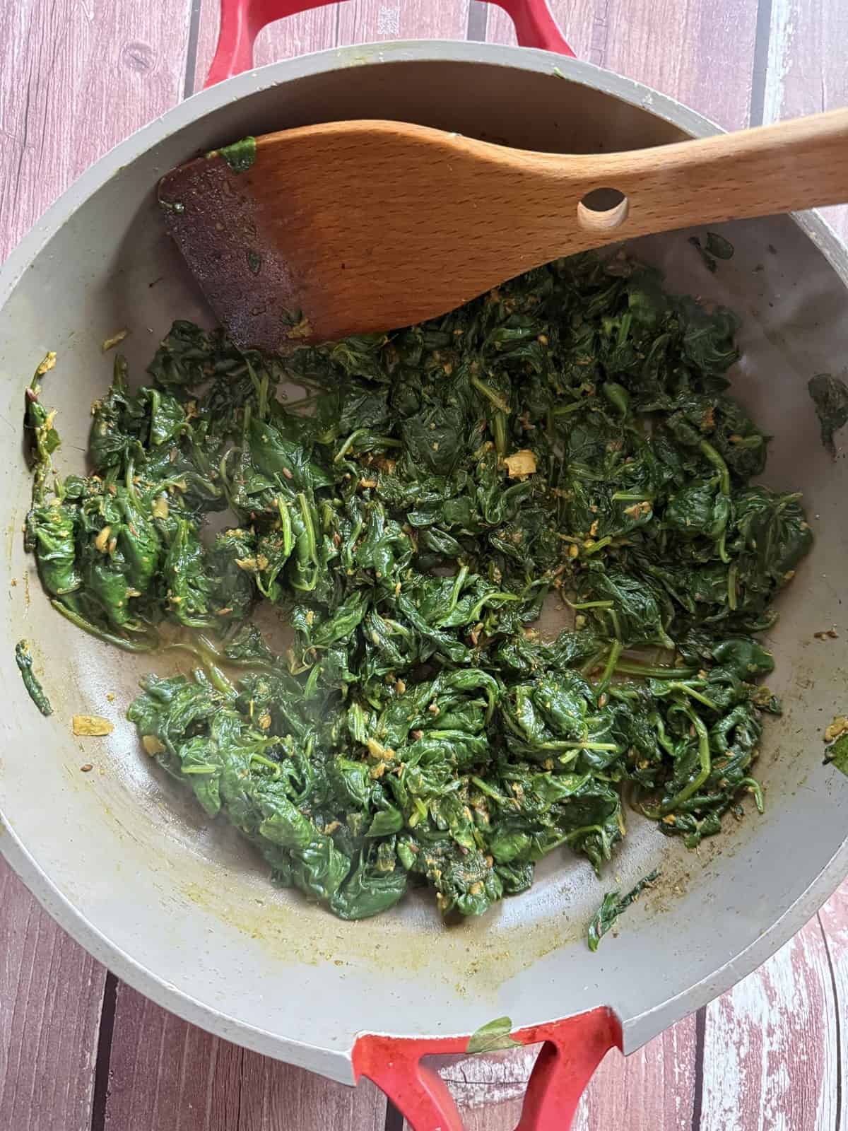 Baby spinach wilting directly into a simple masala for the no blender palak paneer method.